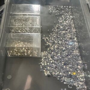 Box with loose stones and 3 containers of non hotfix to bundle with the rest